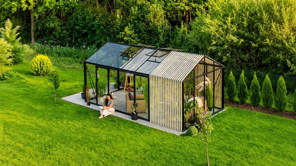 Bloomcabin Classic Premium aluminum greenhouse with Accoya wood detailing, sliding glass doors, roof ventilation windows, integrated gutter system, and luxury garden greenhouse design for year-round gardening and relaxation.
