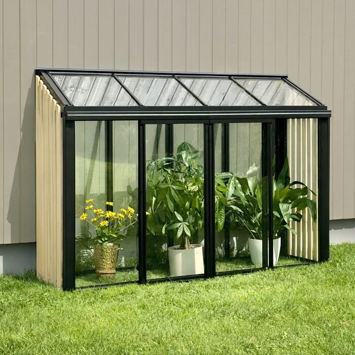 Bloomcabin mini greenhouse with Accoya wood detailing, wall-mounted aluminum frame, sliding glass doors, compact patio greenhouse design, and durable tempered glass panels for growing herbs and plants in small outdoor spaces.