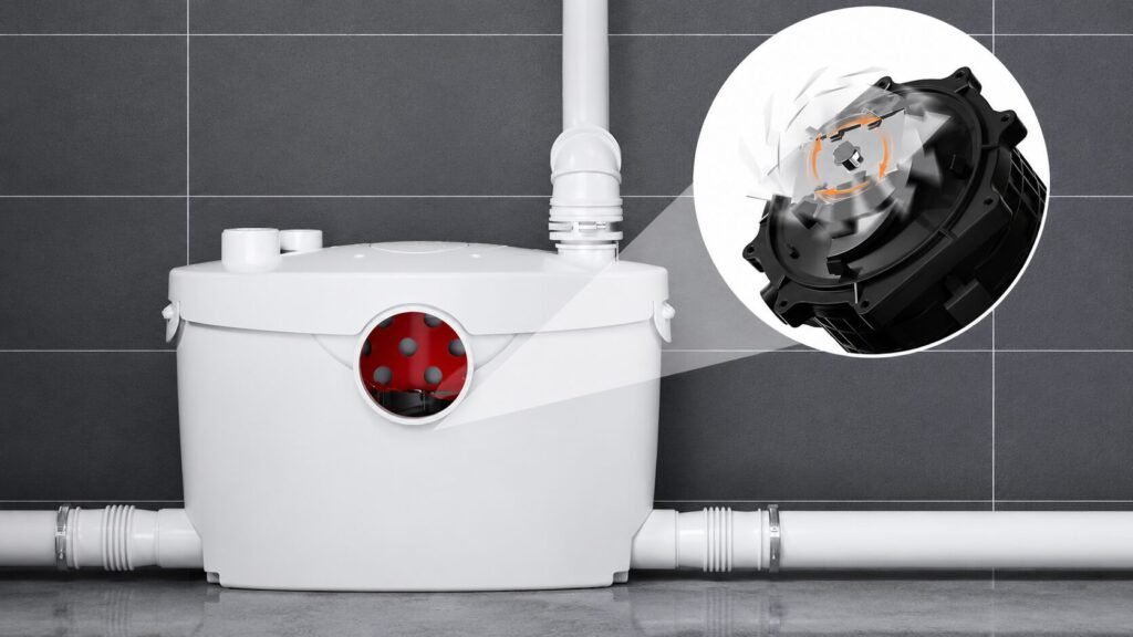 Stainless steel blades mounted above the impeller inside a macerator pump grinding and liquefying solid waste in an upflush toilet system.