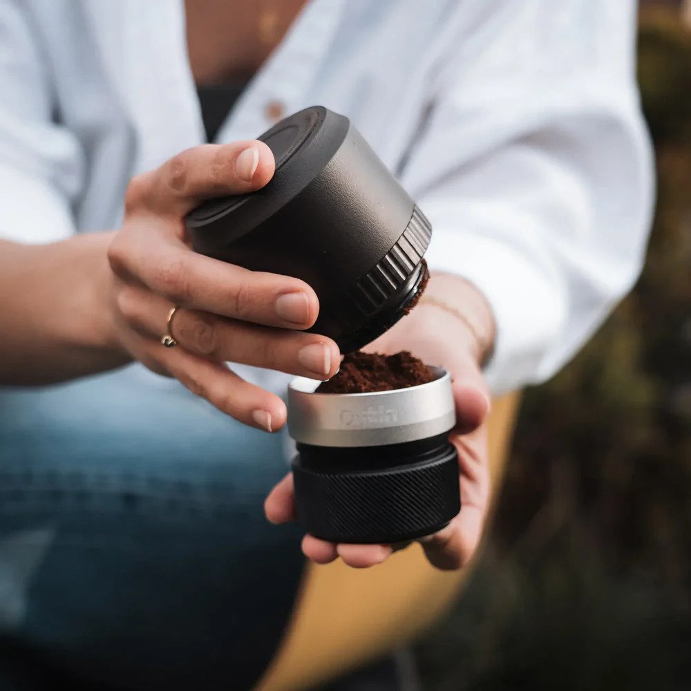 Freshly ground coffee bean powder produced from a portable electric coffee grinder for espresso brewing