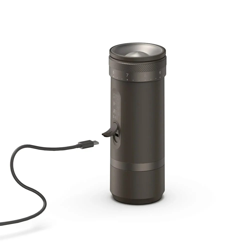 OutIn Fino portable electric coffee grinder charging with USB Type-C cable connected for rechargeable battery power