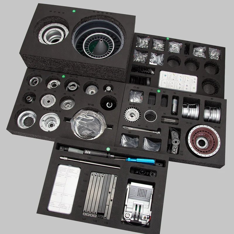 TECHING turbofan engine model kit box contents showing precision machined metal parts arranged in protective foam packaging