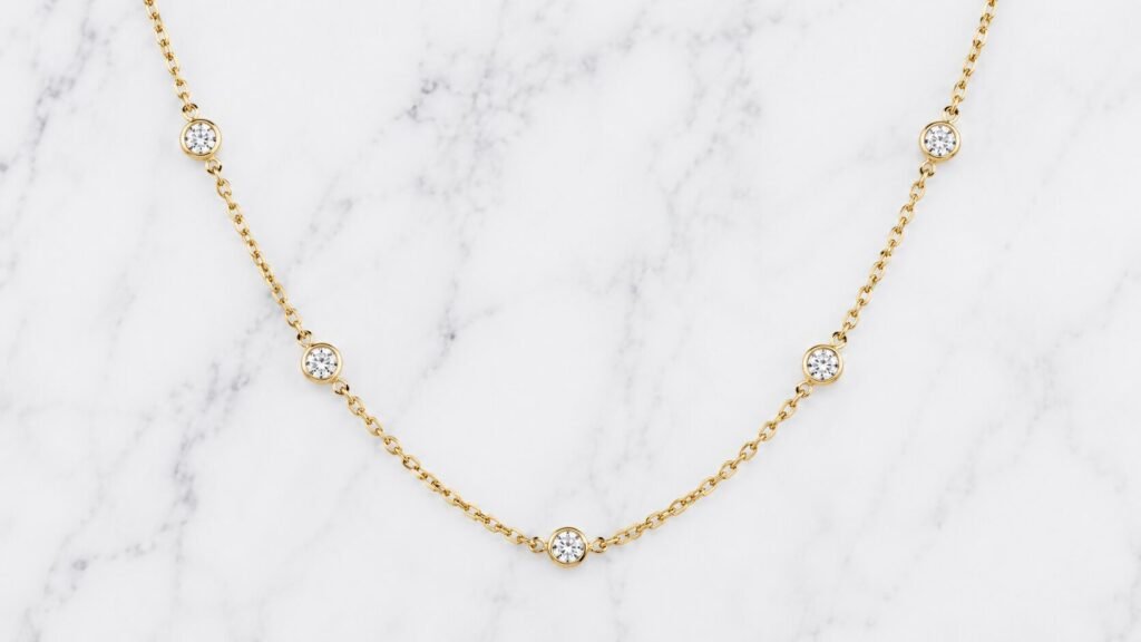 Elegant 14K gold by-the-yard necklace with bezel-set lab-grown diamonds arranged along a delicate luxury chain for everyday layering style.