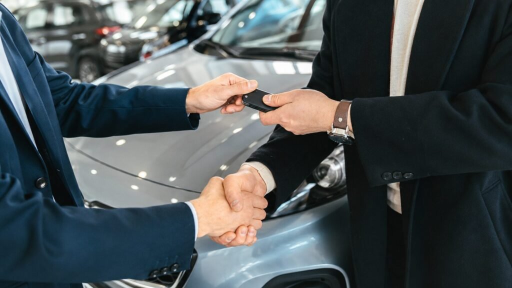 Travelers exchanging car keys beside a rental SUV with luggage during a modern car rental pickup experience
