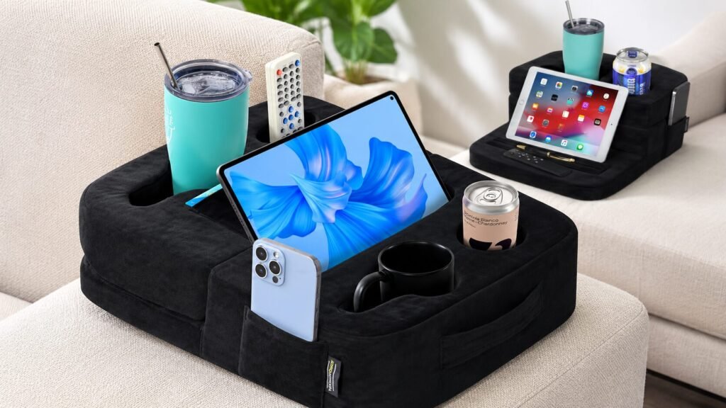 Black TabCouchCaddy couch cup holder and tablet organizer pillow with seven cup holders, adjustable tablet stand, storage pockets, and memory foam comfort.